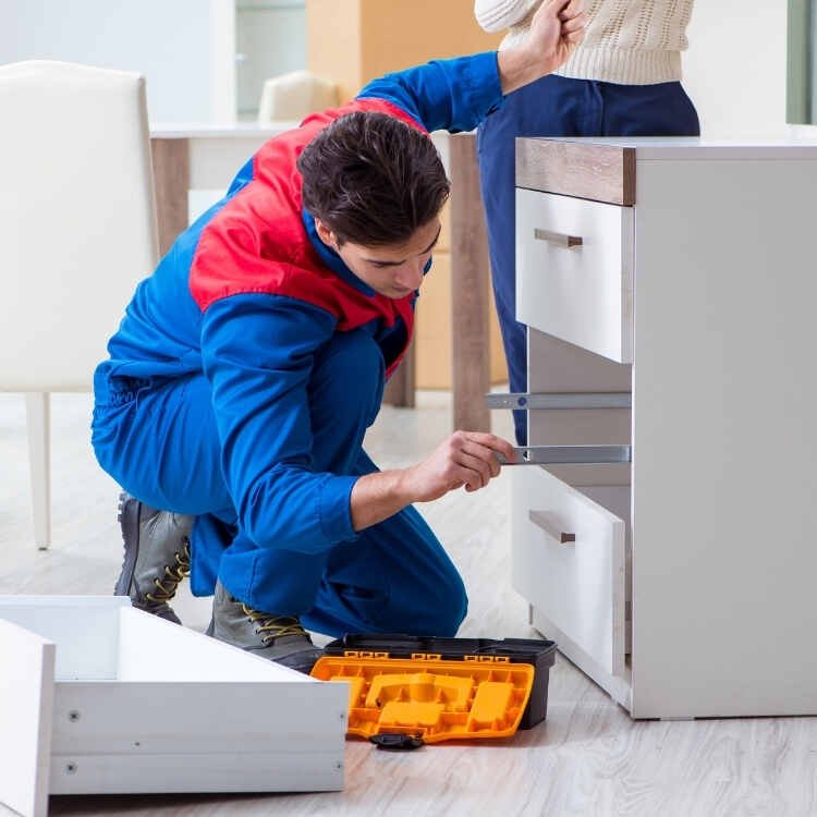 Skilled technicians assembling flat pack furniture quickly and efficiently.